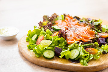 Raw Smoked salmon meat fish with fresh green vegetable salad