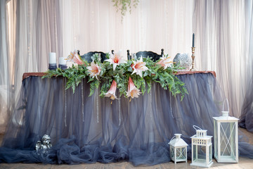 Festive table in blue and gray colors decorated with flowers