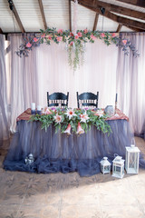 Festive table in blue and gray colors decorated with flowers