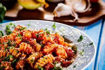 Pasta with vegetables on wooden background