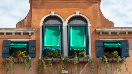 Fototapeta na wymiar Murano, Venezia, Italy. Details of the windows of the traditional houses in Murano island