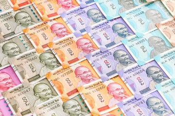 Close up view of brand new indian 10, 50, 100, 200, 500 and 2000 rupees banknotes. Colorful cash money pattern background.