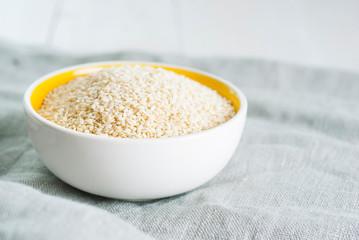 sesame seed variations on creased canvas, white wood background