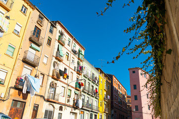 Fototapeta na wymiar view of street with colorful houses in small catalan spanish medieval town during sunny spring day and clear blue sky