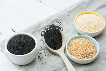 sesame seed variations on creased canvas, white wood background