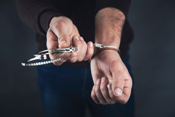 man hand open handcuffs