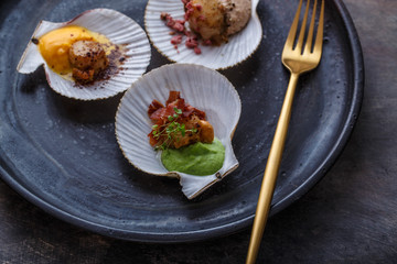 Grilled scallops shell with puree, close view, restaurant dish