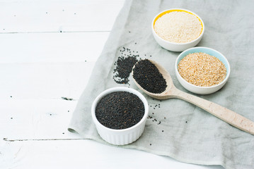 sesame seed variations on creased canvas, white wood background