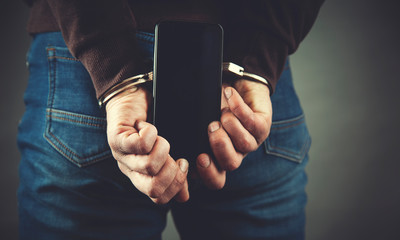 man hand handcuffs and phone