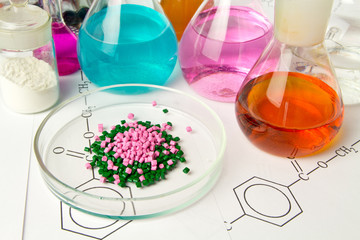 Plastic raw material in granules against the background of Chemical Laboratory and reagents....