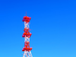 Square rectangle big red white steel beam structure telephone radio masts telecommunication antenna tower architecture on clear gradient blue sky with right blank space