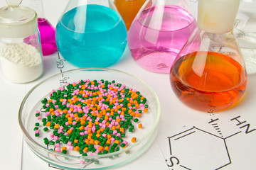Plastic raw material in granules against the background of Chemical Laboratory and reagents. Polypropylene, Ethylene, Polypropylene research in laboratory conditions