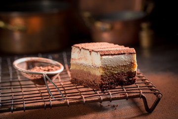 Delicious tiramisu cake with cocoa powder, mascarpone and biscuits