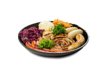assorted sausages with side dishes of potato puree cabbage and beetroot