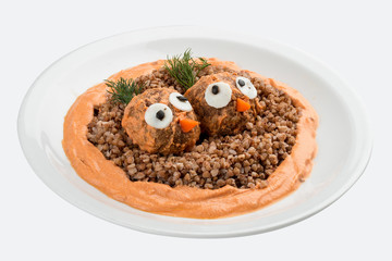 Children's menu. Meatballs with buckwheat porridge and gravy. Decorated with figures of birds. On white background