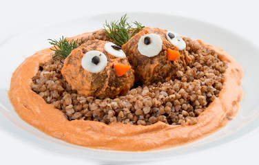 Children's menu. Meatballs with buckwheat porridge and gravy. Decorated with figures of birds. On white background