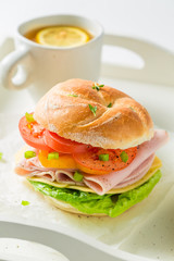 Closeup of tasty sandwich with cheese, ham and tea