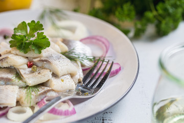 Plate of herring with oil and onion, greek style food.