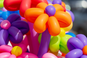 Multicolored flowers from balloons as background
