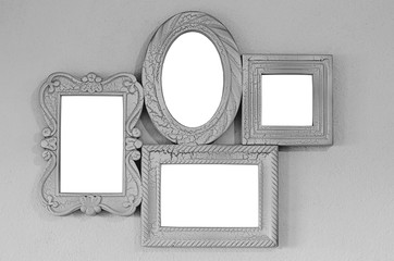 A collage of four empty photo frames on a gray wall, decor layout. Isolated on white background