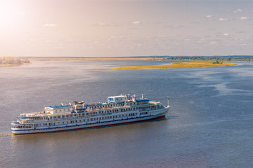White cruise ship sailing on the river