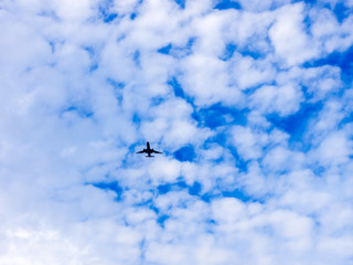 Airplane flying in the blue sky with clouds. Tel-Aviv, Israel