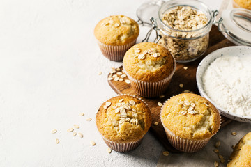 Homemade tasty oat miffins on white background