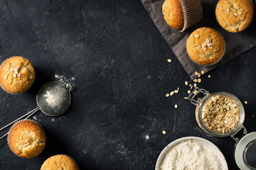 Ingredients for making oat muffins on black texture