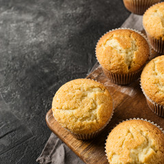 Homemade tasty miffins on black background, close up