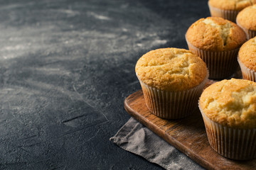 Homemade tasty miffins on black background, close up