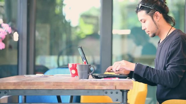 freelance man typing on computer laptop in home office