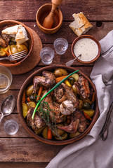Oven baked rabbit with potato and carrots, top view