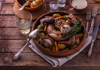 Baked rabbit with potato and carrots, top view