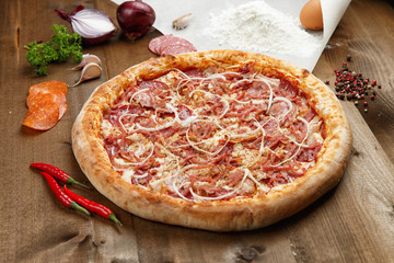 homemade pizza on wooden background