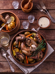 Rabbit with potatoes and carrots baked in a ceramic pot