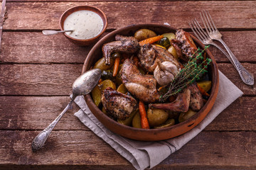 Oven baked rabbit with potato and carrots, copy space