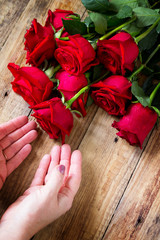 Mother day or Valentines Day, wedding card. Beautiful blooming Red roses on rustic wooden board.