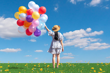 free happy woman enjoying sunrise. Beautiful woman with holding balloon in blue sky enjoying peace
