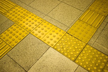 Tactile paving to assist the vision impaired navigate a train station in Osaka.