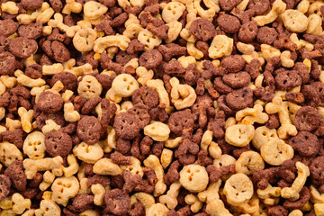  Chocolate flakes in the form of skulls and bones background. Top view.