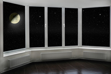 window with view to Moon and dark night sky. Stars and moon
