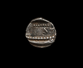 Ancient silver coin isolated on black
