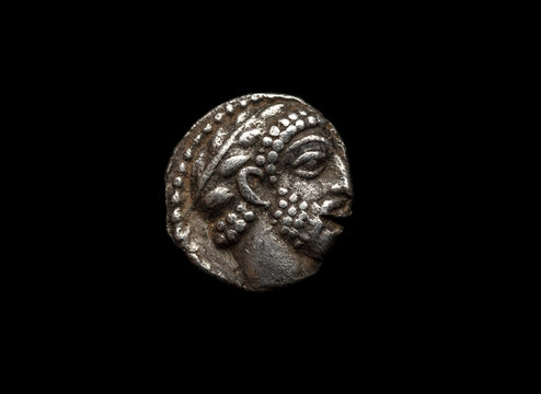 Ancient silver coin isolated on black