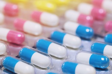 close up pharmaceuticals antibiotics pills medicine in blister packs. colorful antibacterials pills Pharmacy background. capsule pill medicine Antimicrobial drug resistance. Pharmaceutical industry