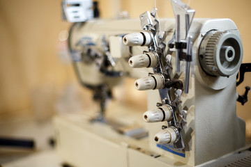 closeup details on sewing machine overlock. Workplace seamstress.Tailoring industry