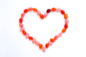 Heart shape  made of jelly beans isolated on white