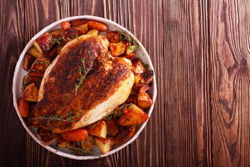 Thyme rooster crown with potatoes and carrots