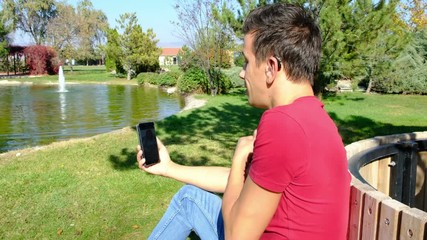 Young boy communicating with sign language at smart phone