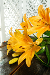 Fototapeta premium Sensual bouquet of beautiful orange lilies flowers close up