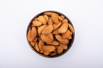 Almonds in a bowl and isolated on white